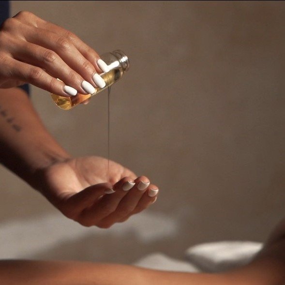 Therapist providing a relaxing spa treatment with essential oils at Oceanic Spa